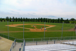 people playing baseball on a baseball field