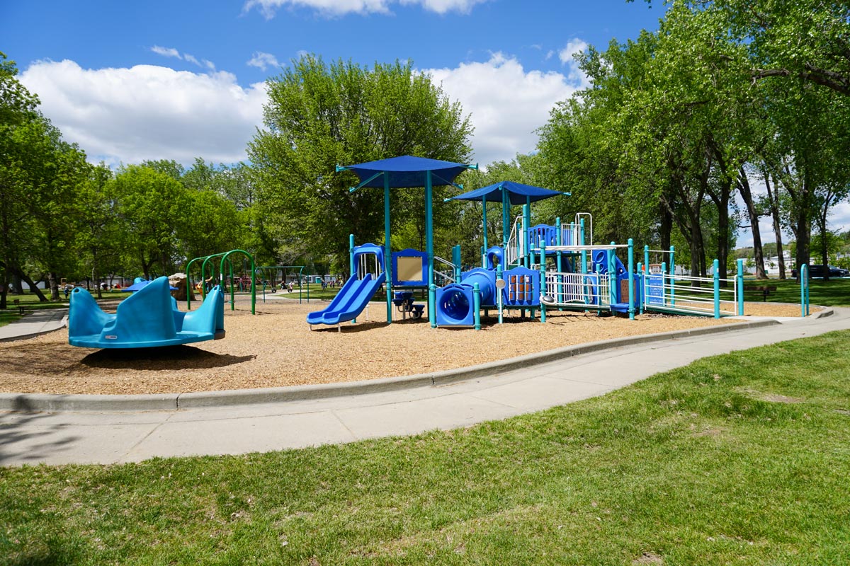 blue playground with trees in the background at Kiwanis Park