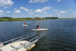 people kayaking near a kayak ramp at McDowell Dam Recreation Area