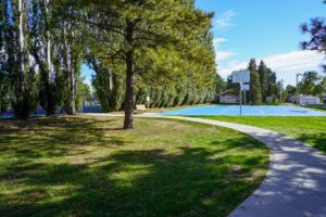 basketball court and park bench surrounded by trees at North Central Park