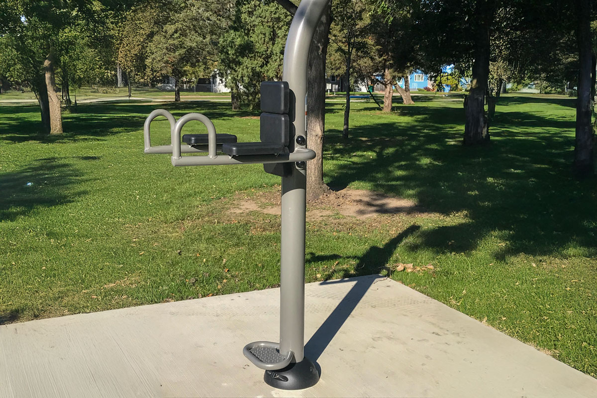 captain's chair (ab crunch) fitness equipment in a park along a fitness trail