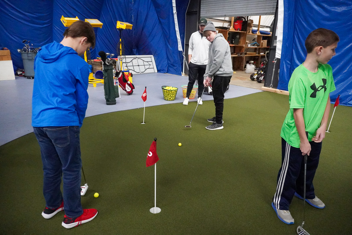 youth putting at Fore Seasons Center during a DJGA golf clinic